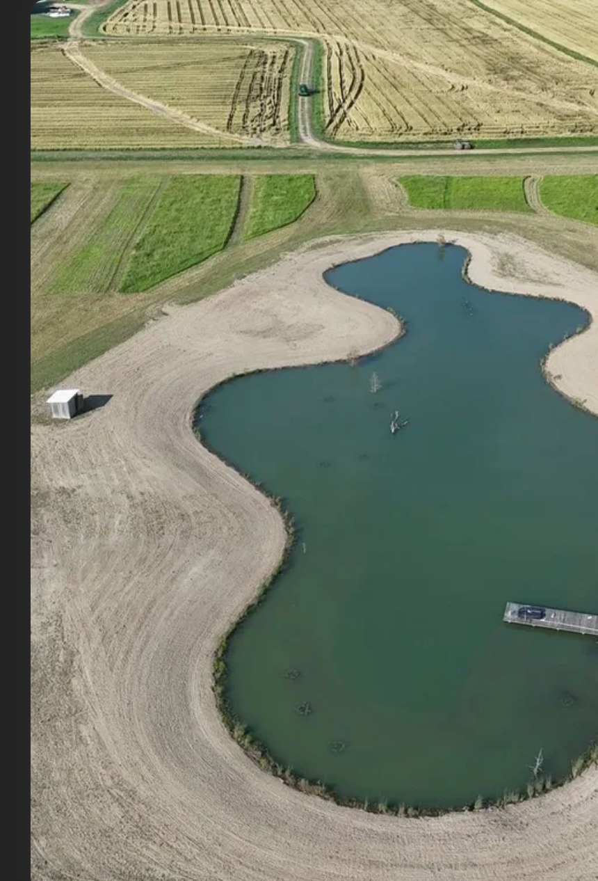 Aerial view of a stabilized pond and surrounding site