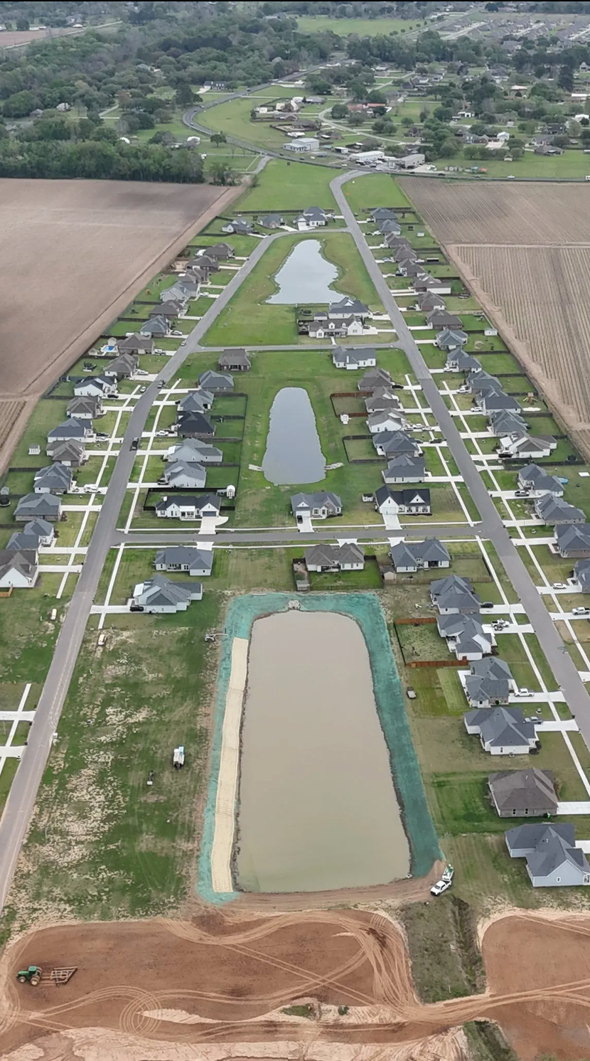 Aerial view of a residential development with pond-edge stabilization